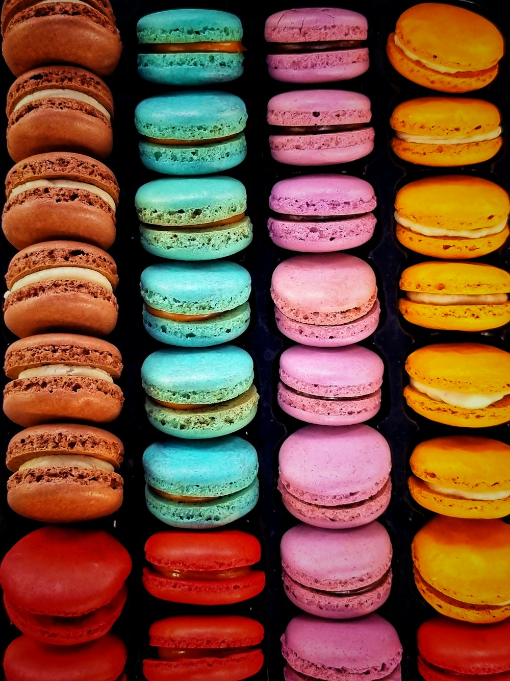 a bunch of different colored macaroons on a table