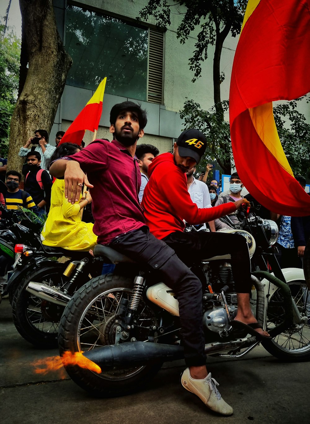 a group of people riding on the back of a motorcycle