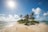 A small tropical island with a sandy beach surrounded by clear blue ocean waters. The sky is bright with a few scattered clouds, and the sun is shining brightly. The island is dotted with palm trees and some green vegetation.