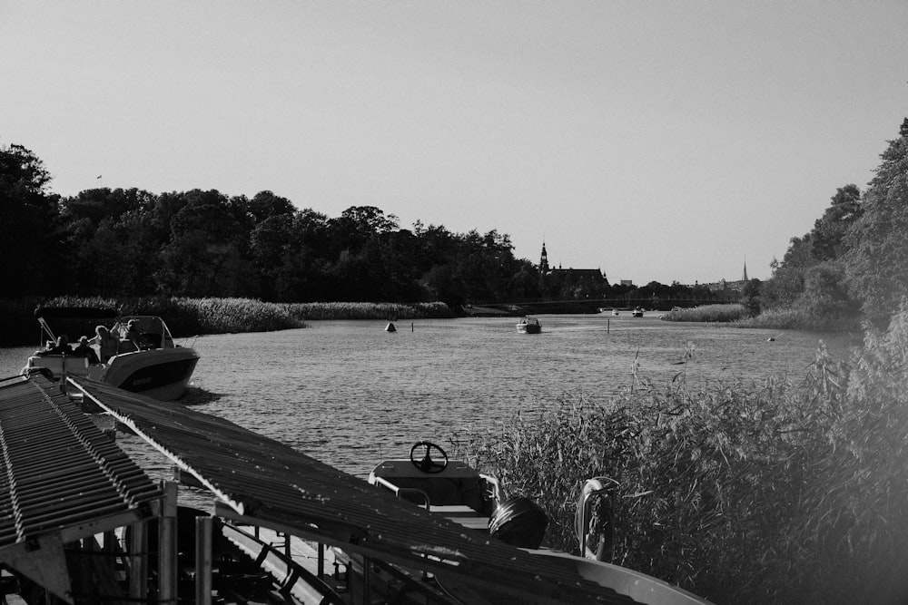 a black and white photo of a boat on a river