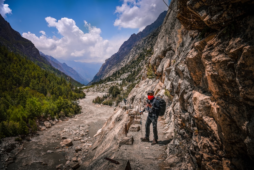 a man standing on the side of a mountain