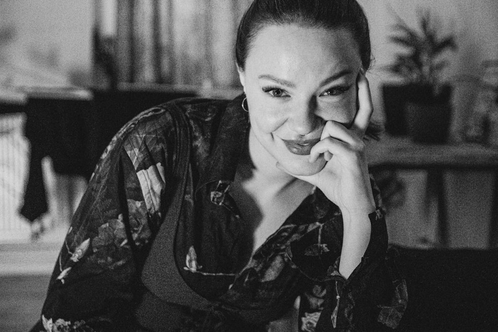 a black and white photo of a woman talking on a cell phone