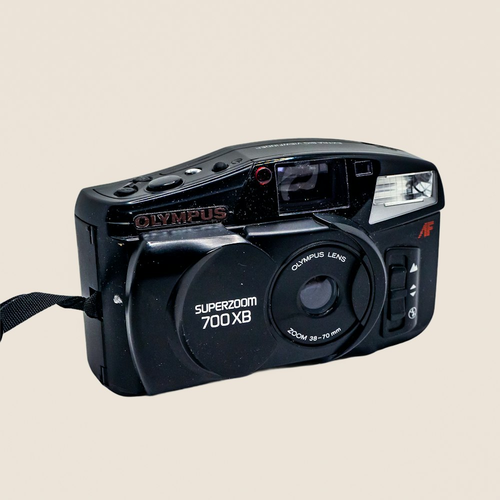 a black digital camera with a white background