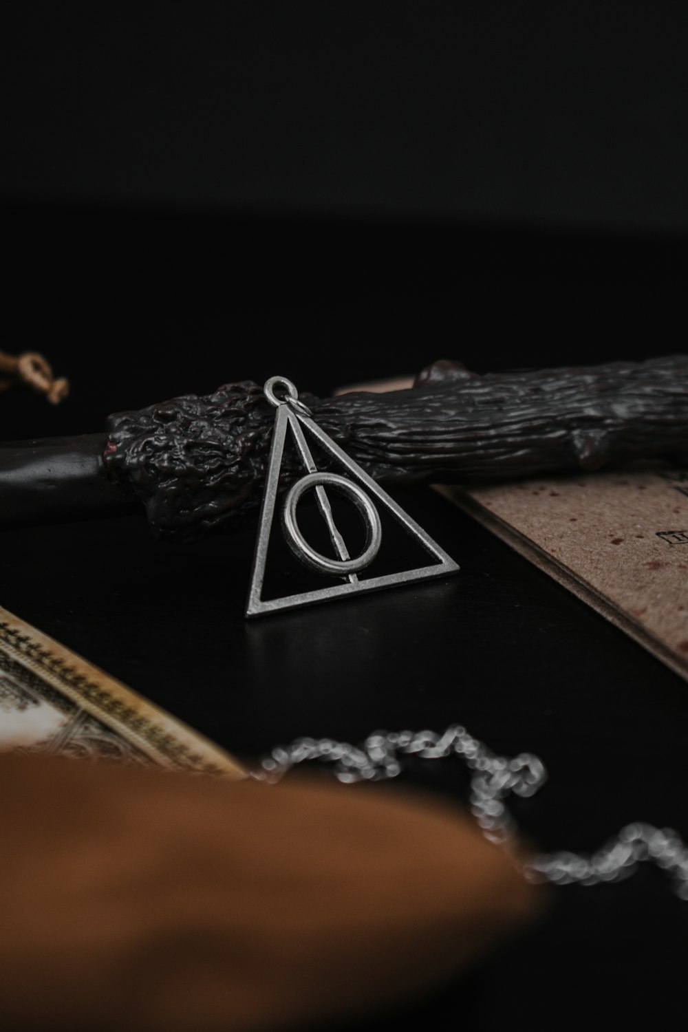 a harry potter necklace sitting on top of a table