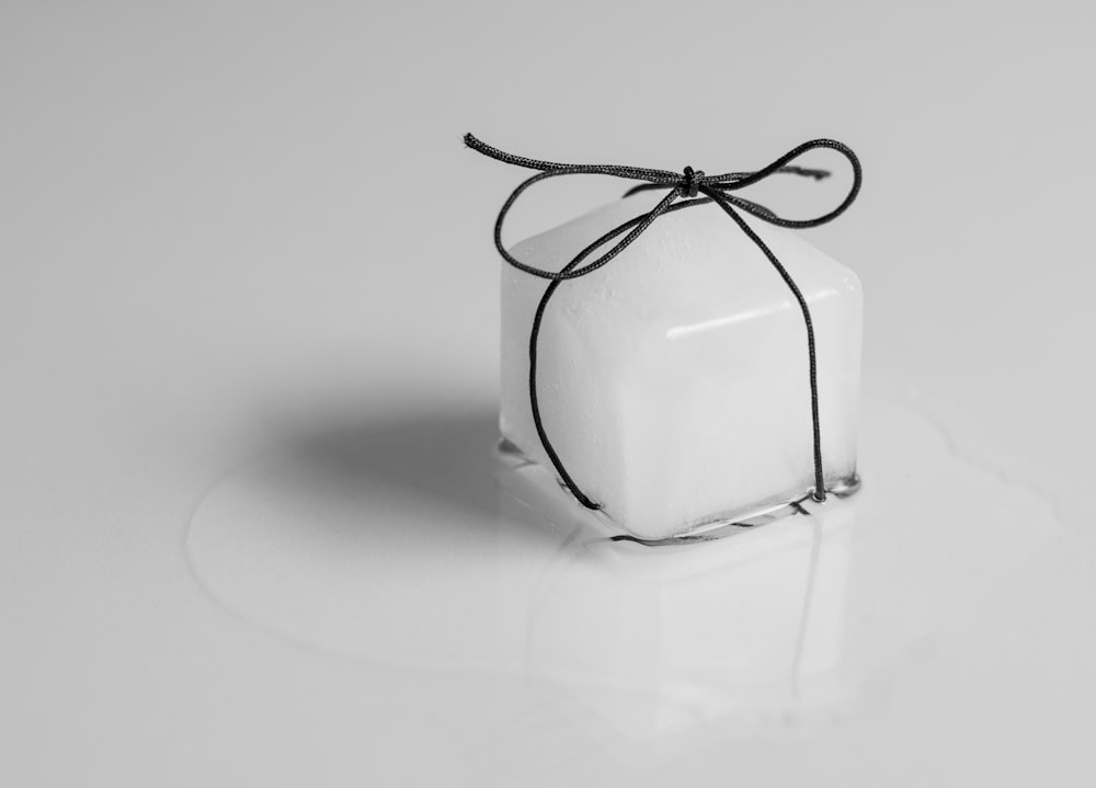 a white square box tied with a black string