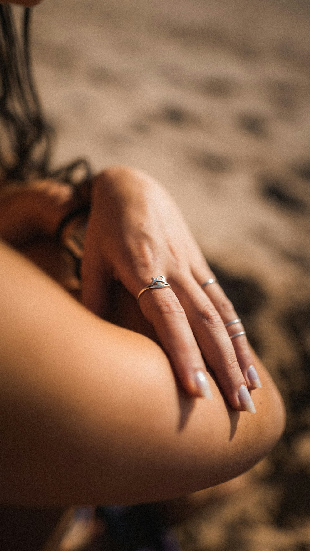 a close up of a person's hand with a ring on it