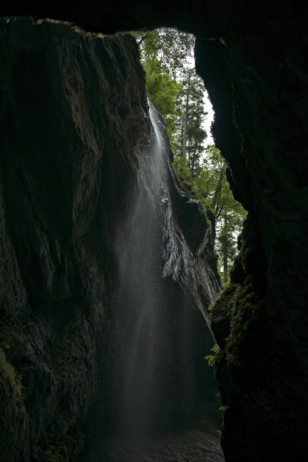 a cave with a waterfall coming out of it