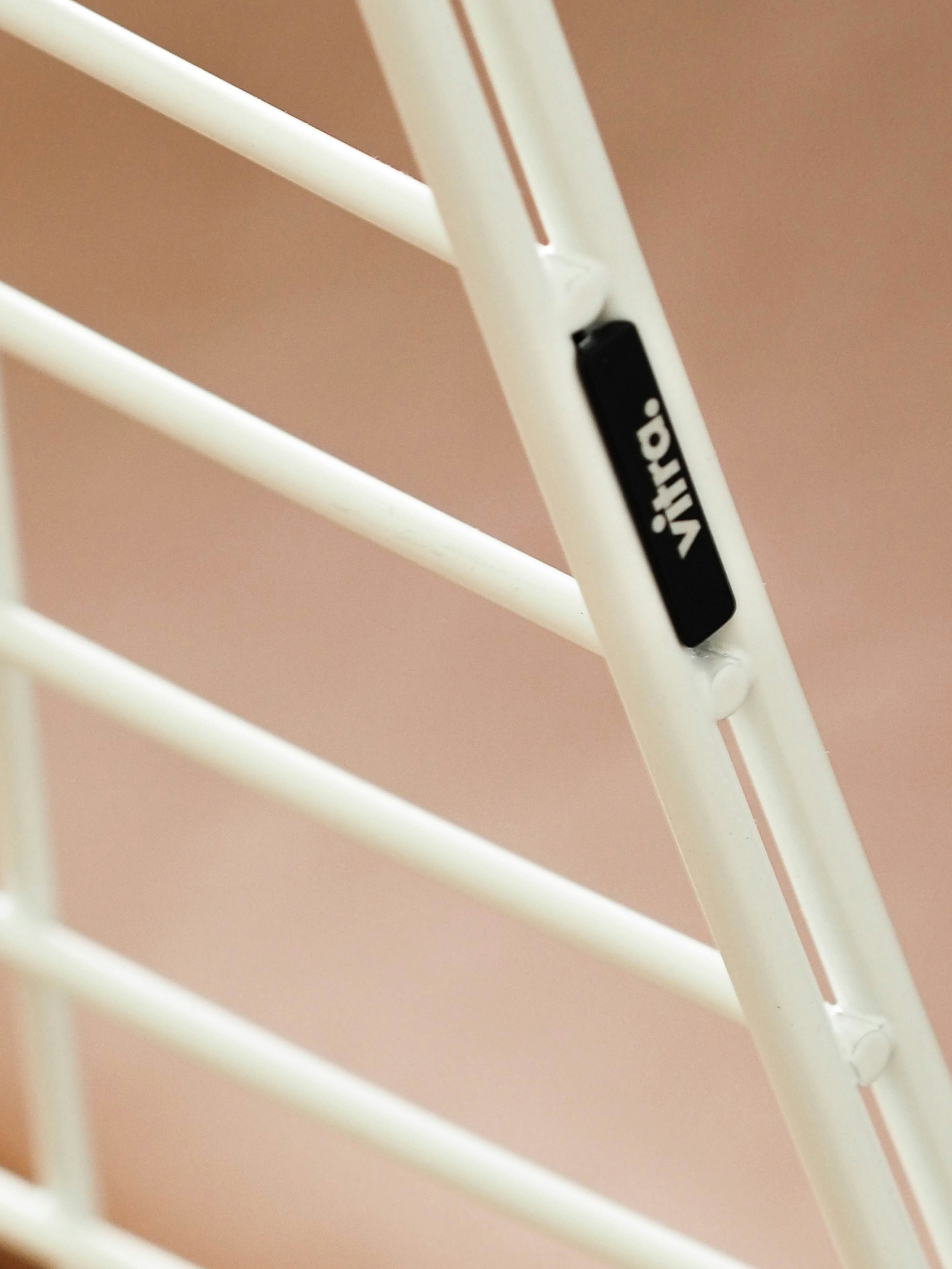 a white ladder with a black tag on it