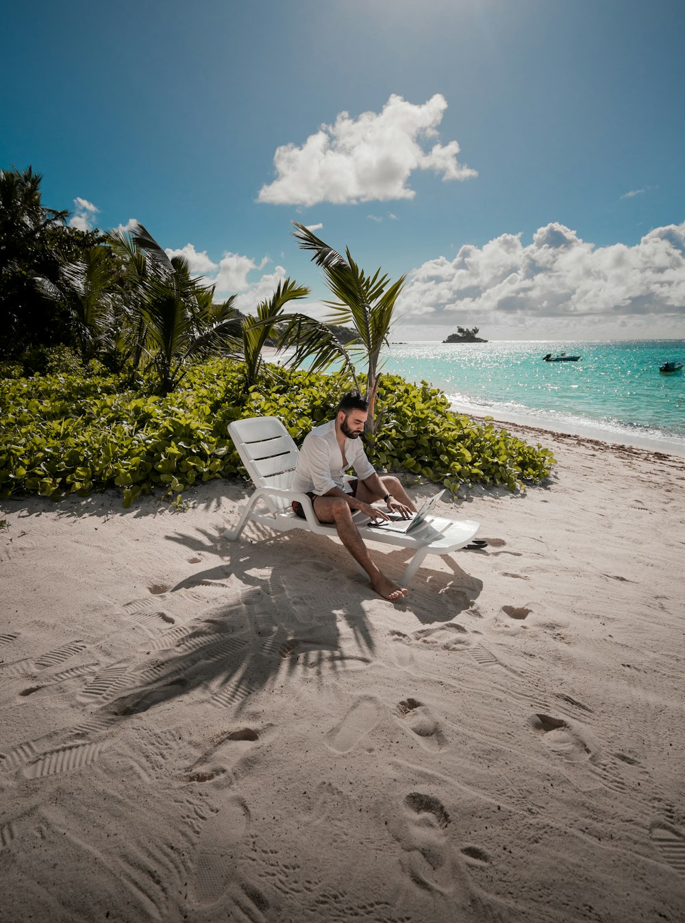 a man sitting in a chair on the beach