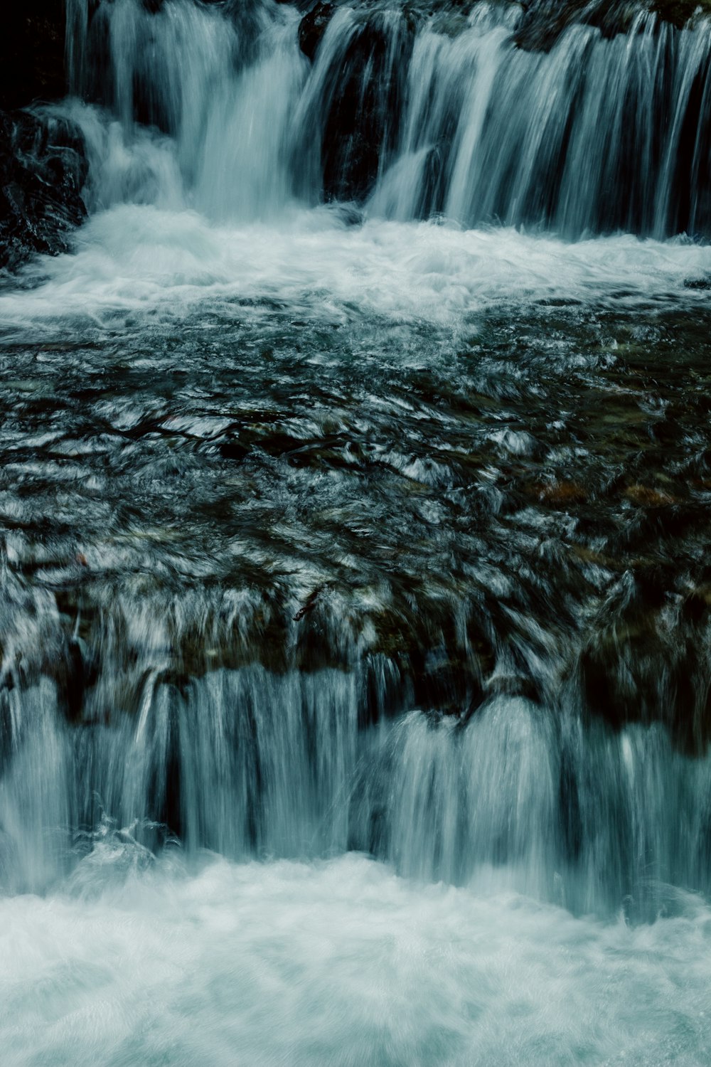 a small waterfall with lots of water running over it