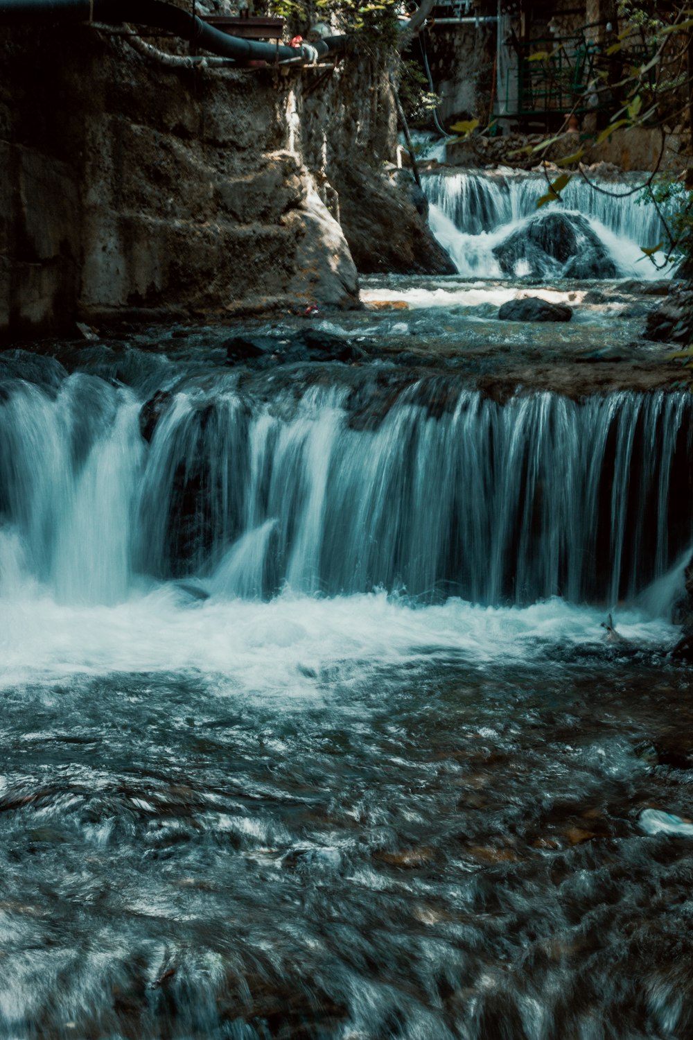 a small waterfall in the middle of a forest