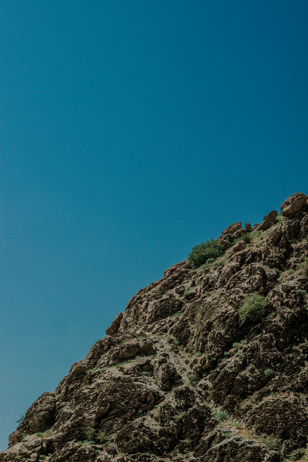 a man standing on top of a rocky hill