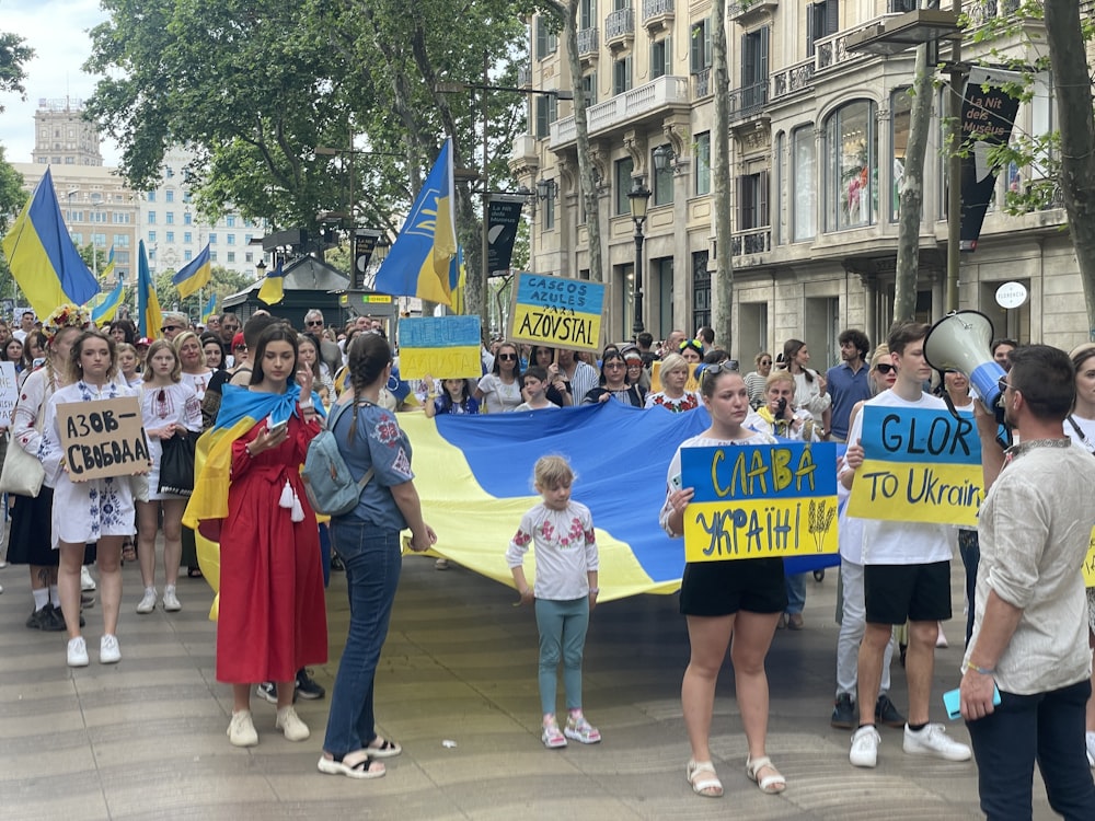 a group of people holding a large blue and yellow banner