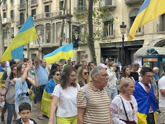 Volunteers handing out campaign flyers in a busy city street, engaging with diverse people.