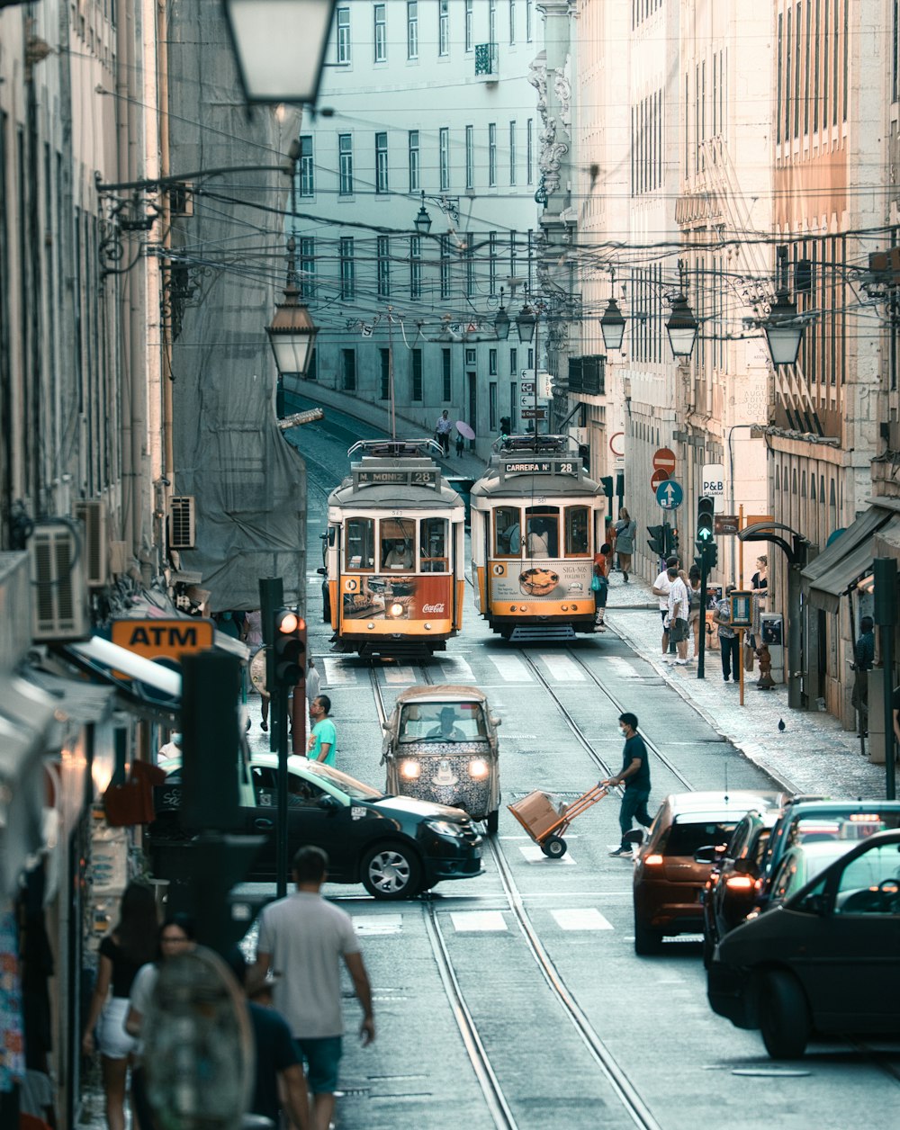 a couple of trolleys that are going down a street