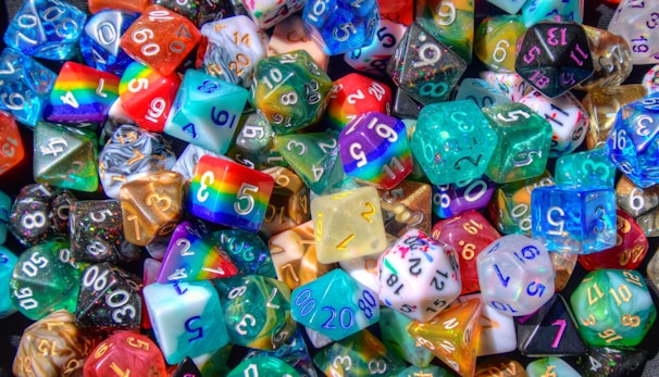 A collection of fantasy dice with vivid colors and unique symbols.