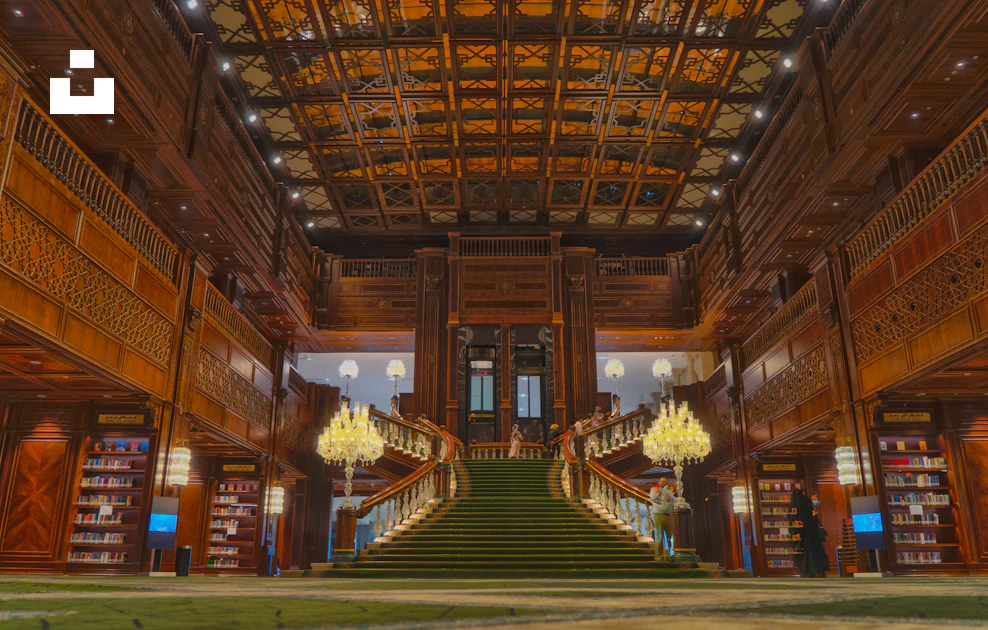 A large library with a staircase and chandelier photo – Free Iran Image ...
