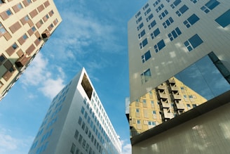 a couple of tall buildings sitting next to each other