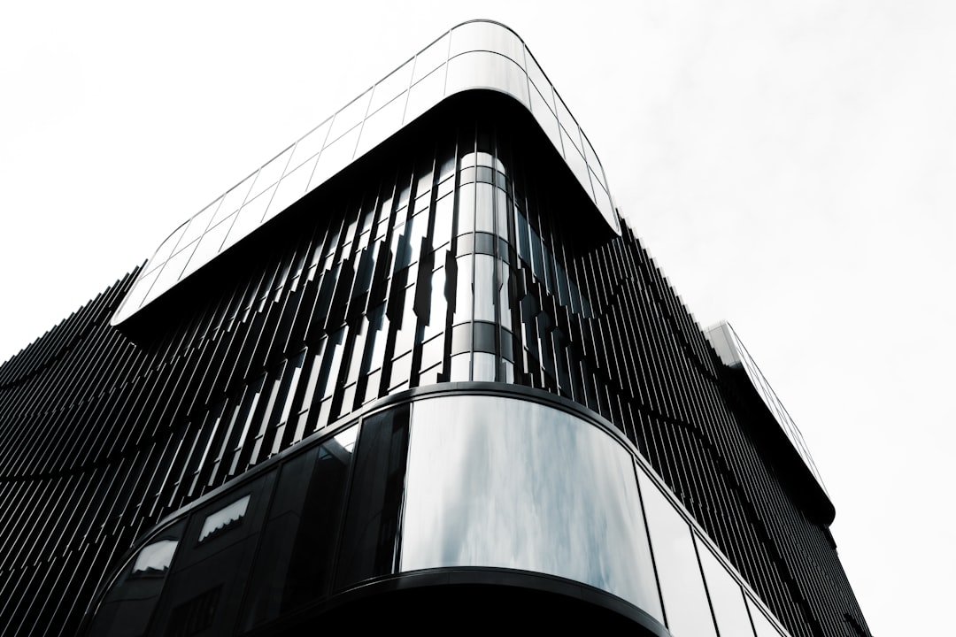 a tall black building with a sky background,