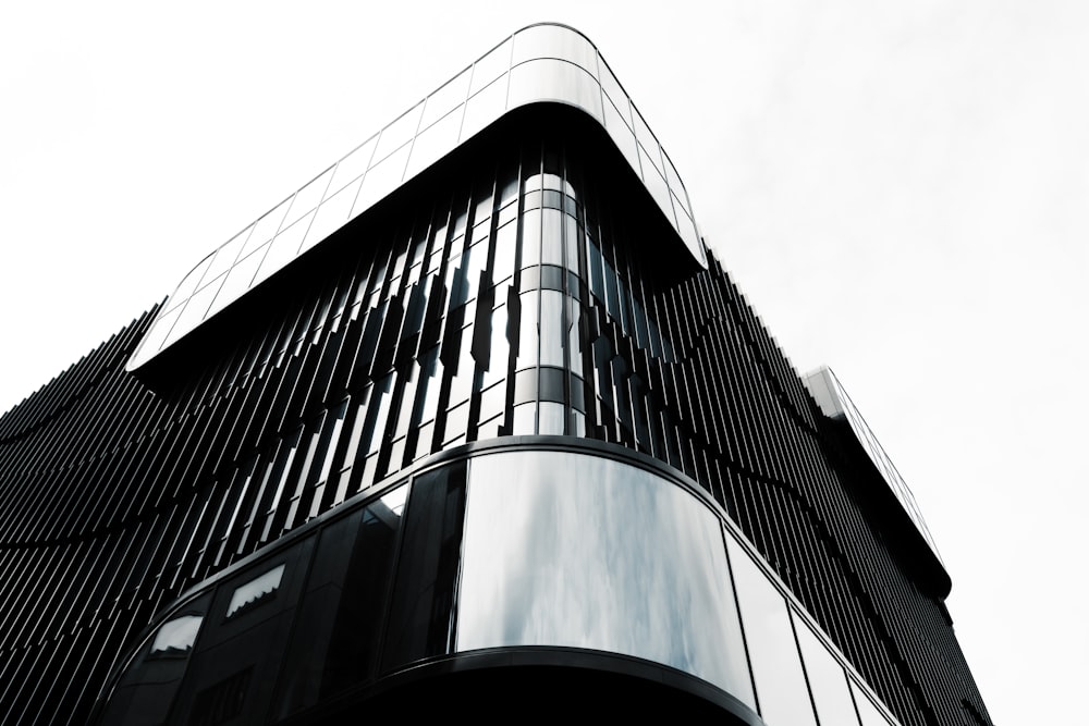 a tall black building with a sky background