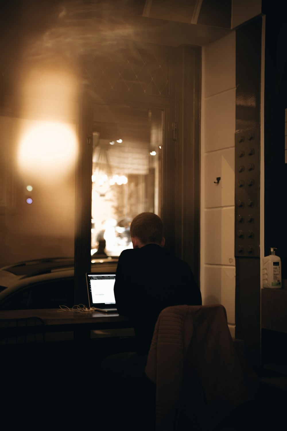 a man sitting in front of a laptop computer