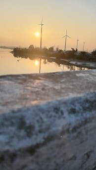 A serene landscape of wind turbines at dusk, reflecting long-term energy vision.