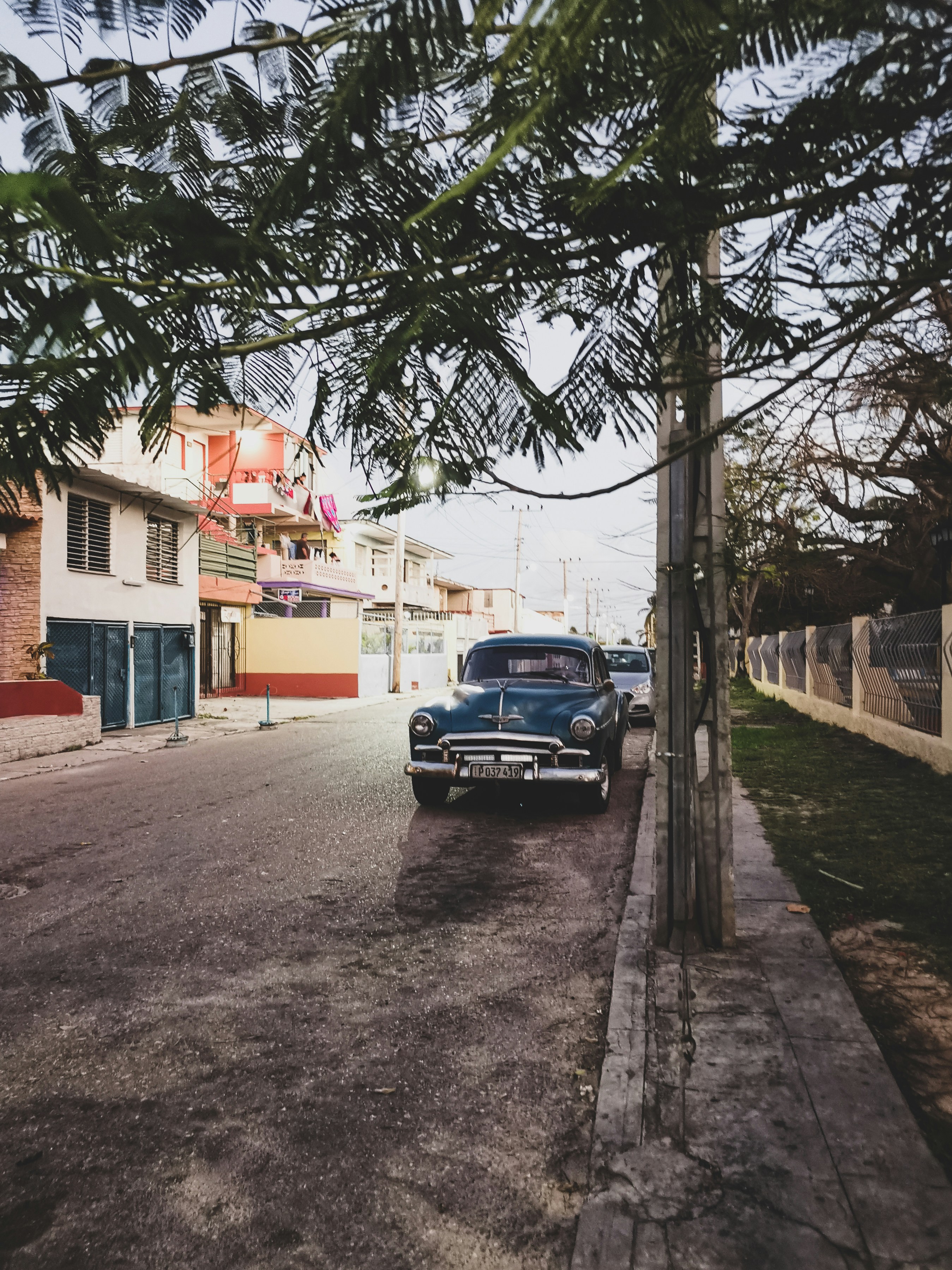 an old car parked on the side of the road