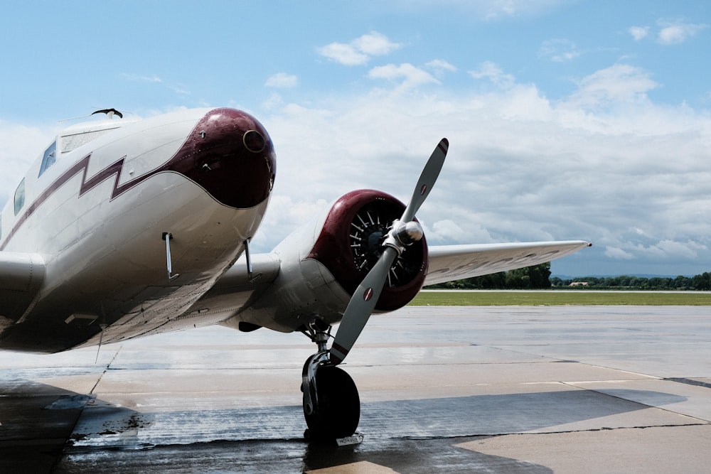 a propeller plane sitting on top of an airport tarmac