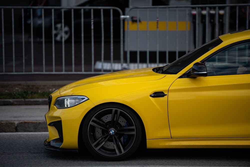 a yellow car parked on the side of the road