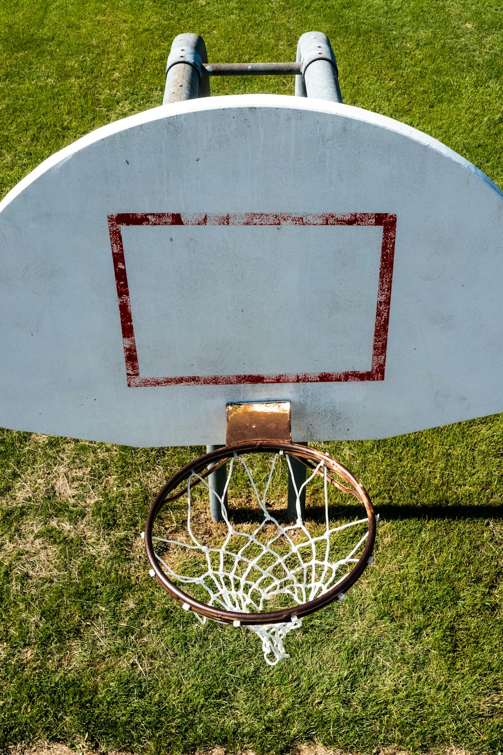 an overhead view of a basketball hoop in the grass
