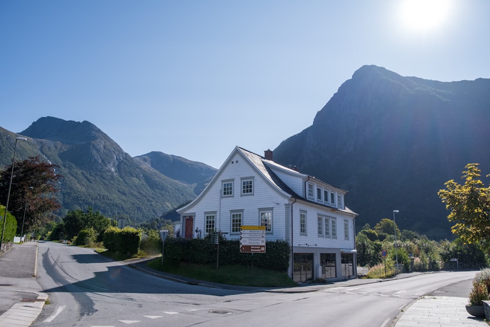 a white house sitting on the side of a road