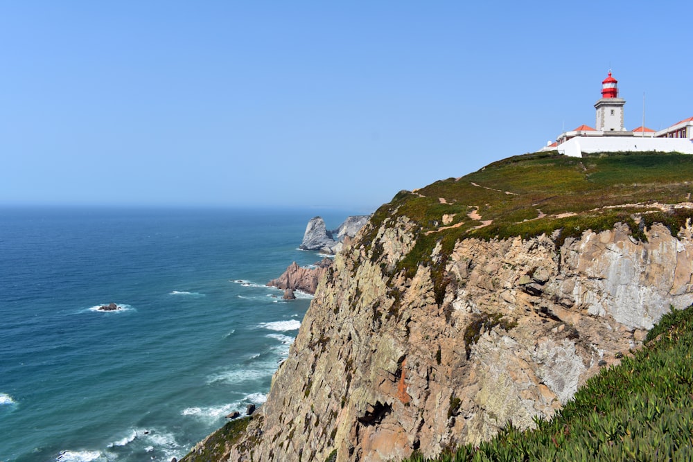 a lighthouse on a cliff overlooking the ocean