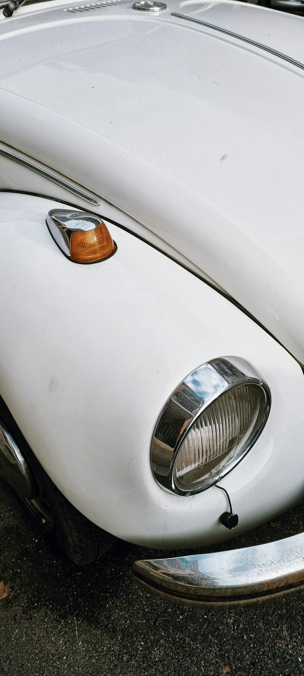 a close up of the front end of a white car