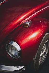a close up of the front end of a red car