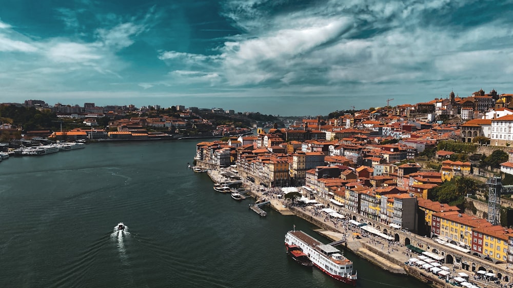 a boat traveling down a river next to a city