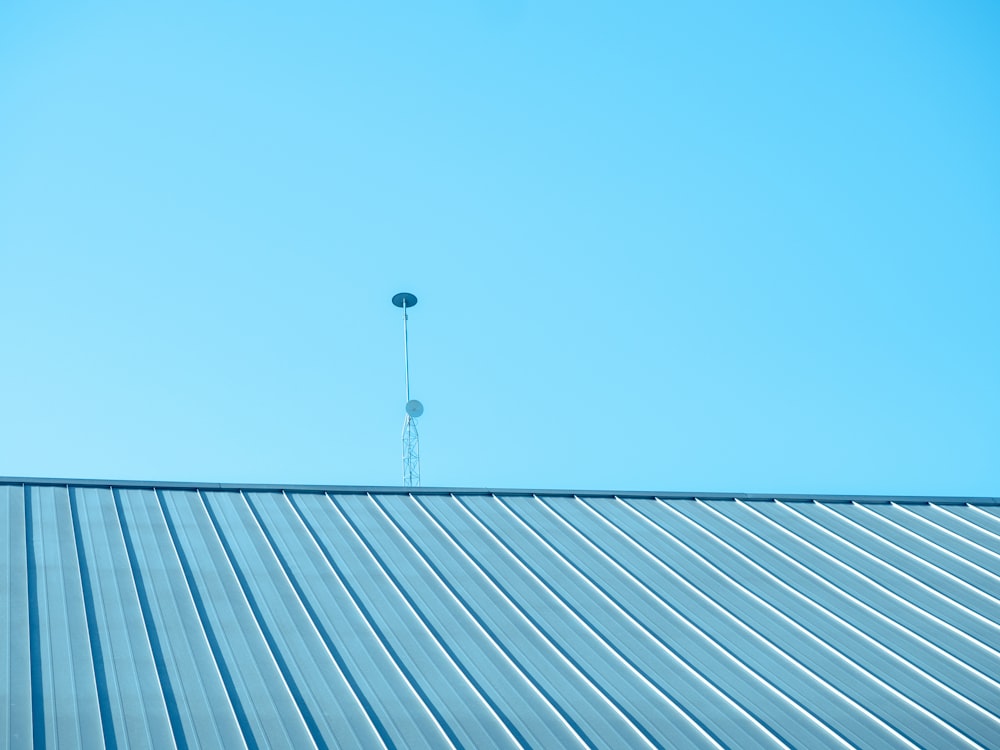 a view of the top of a building with a radio tower in the background