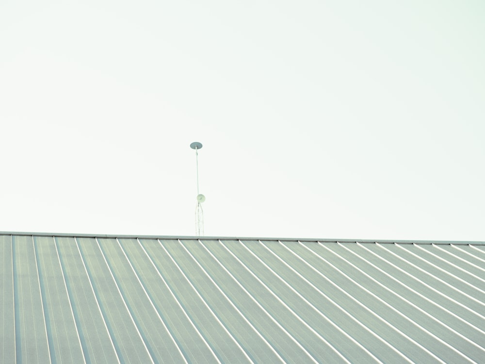 a man riding a skateboard on top of a metal roof