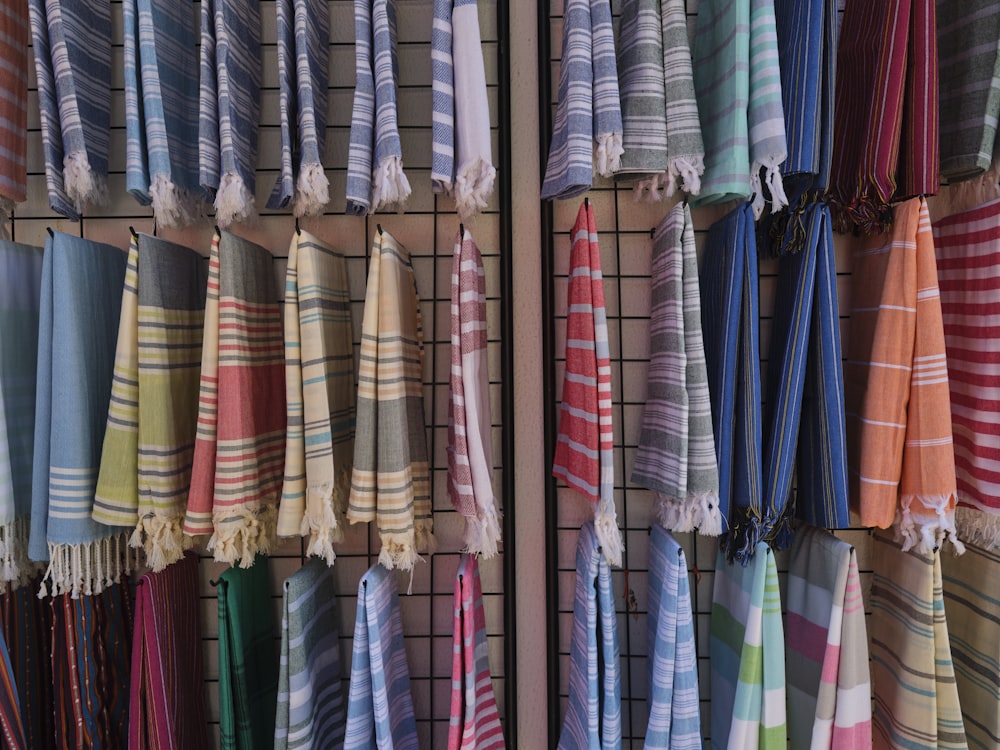 a bunch of towels hanging up on a rack