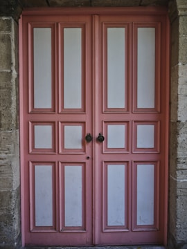 Elegant raised panel cabinet door painted in soft cream.