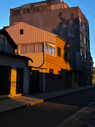 an orange building with a clock on the side of it