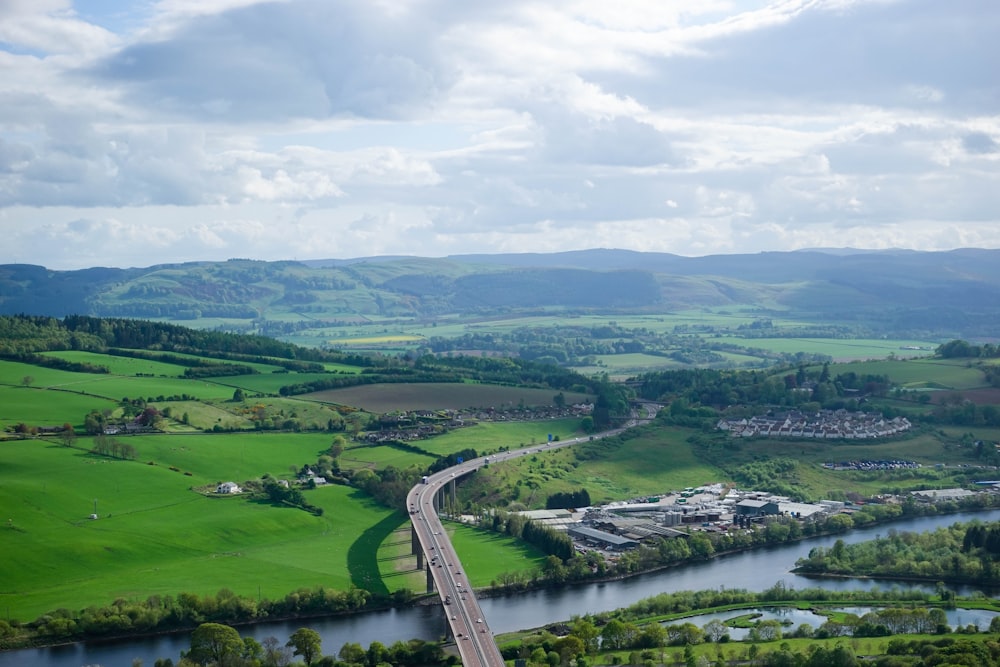 an aerial view of a road and a river