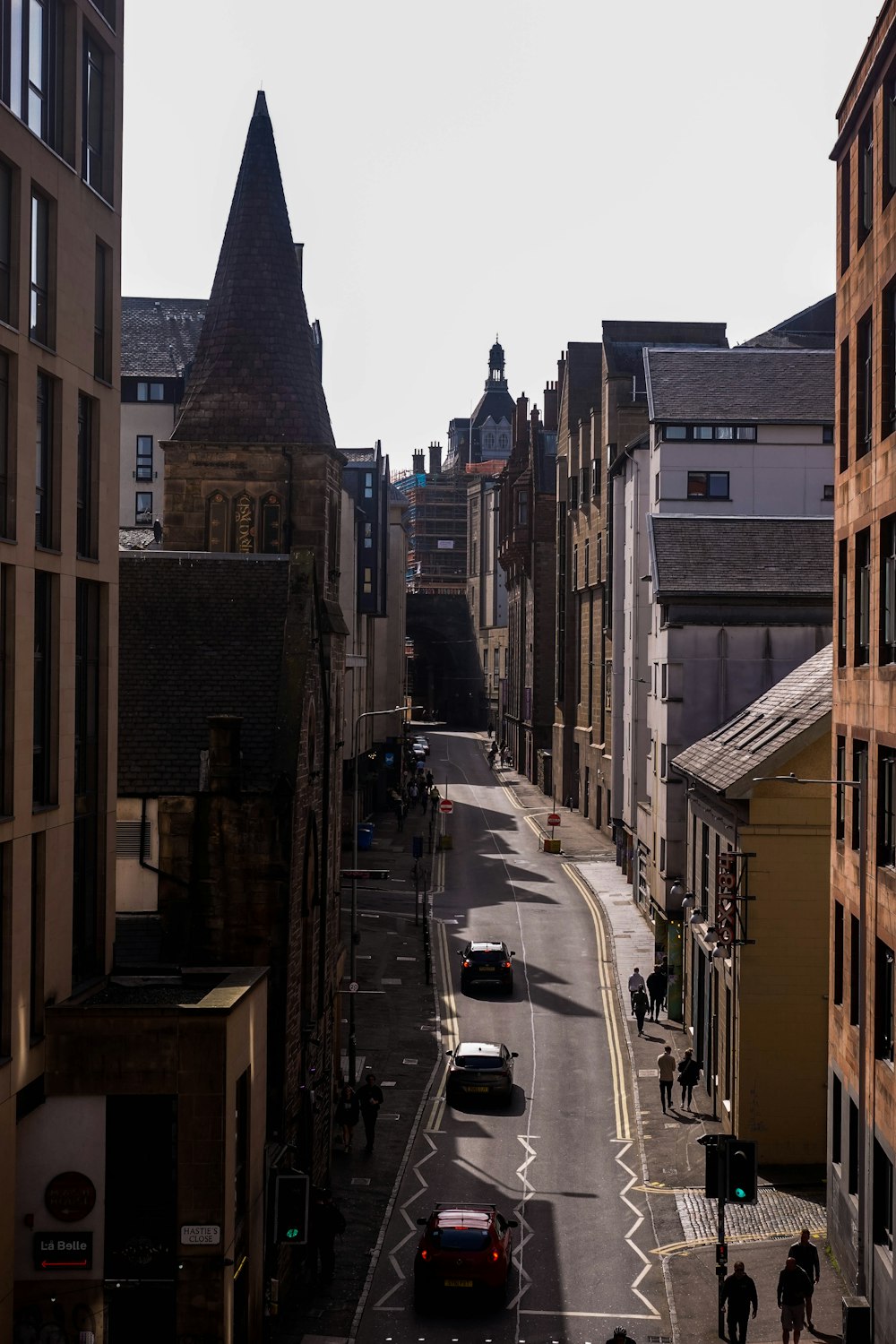 a view of a street in a city with tall buildings