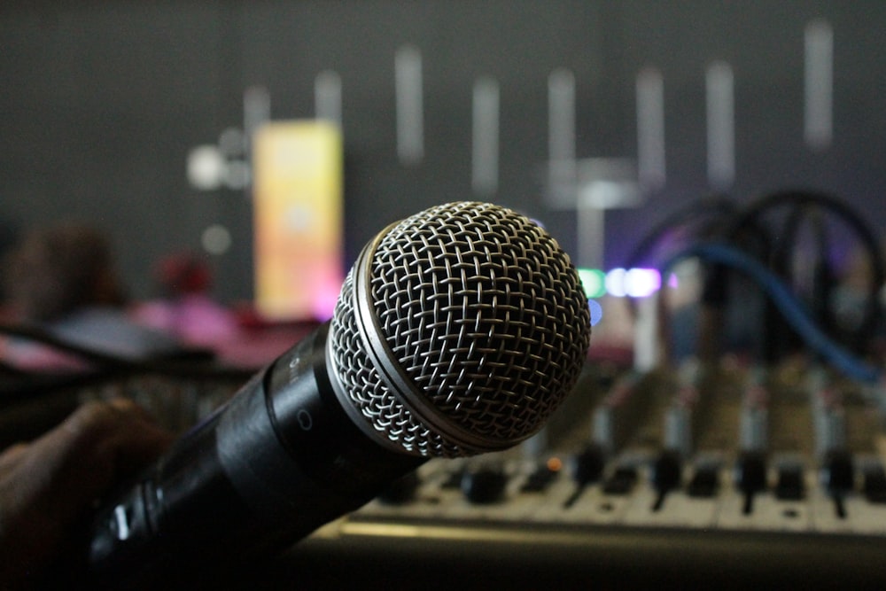 a microphone sitting on top of a mixing desk