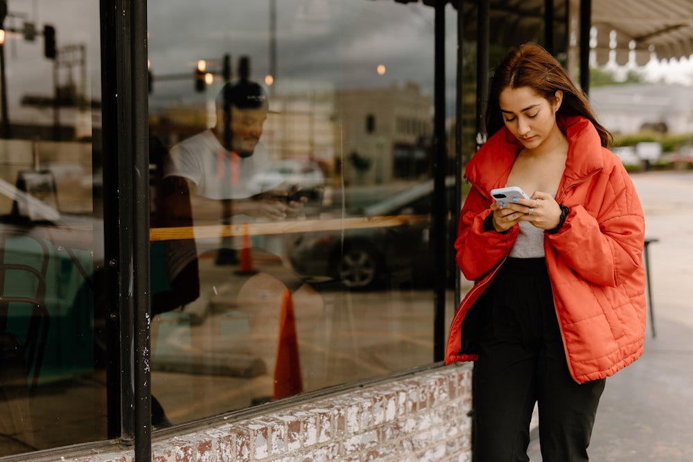 a woman is looking at her cell phone