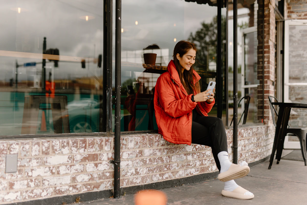 Woman reading a message on her phone by the window