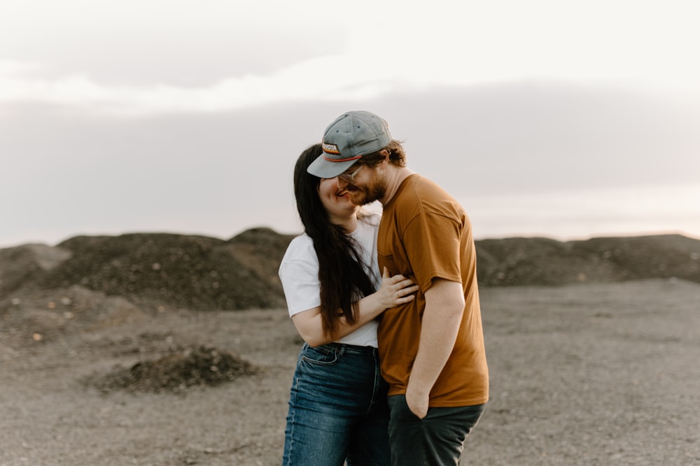 a man and a woman embracing in the desert