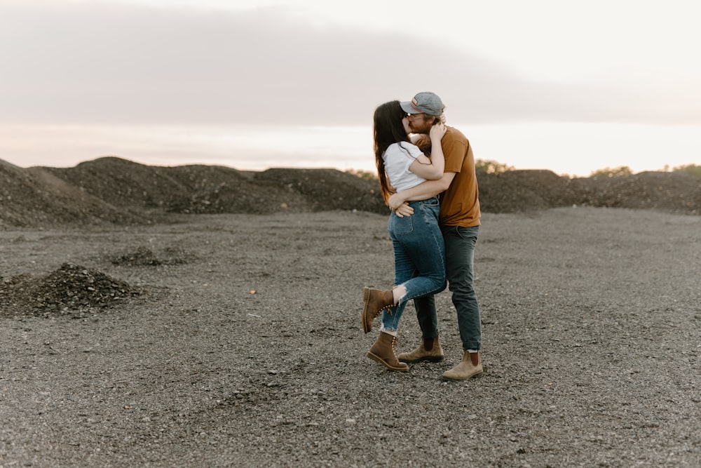 a man and a woman embracing each other in a field