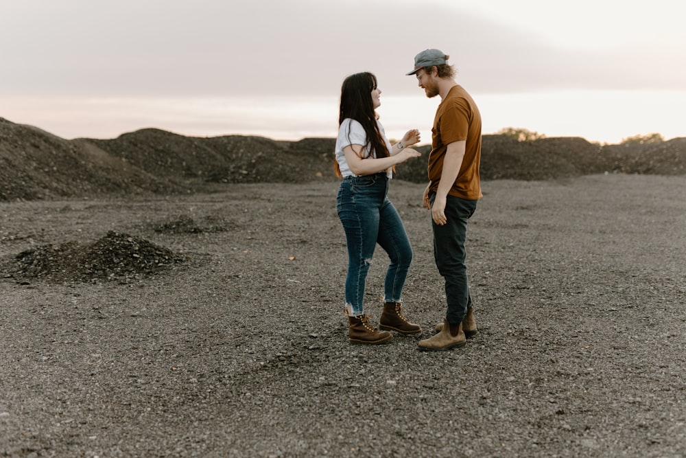 a man and a woman standing in a field