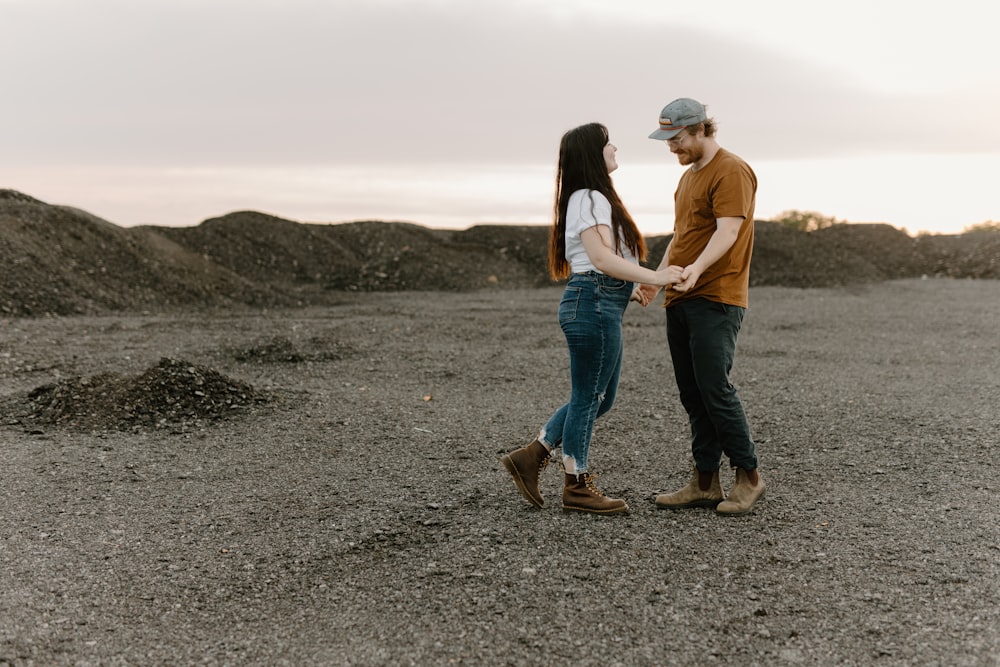 a man and a woman holding hands in a field