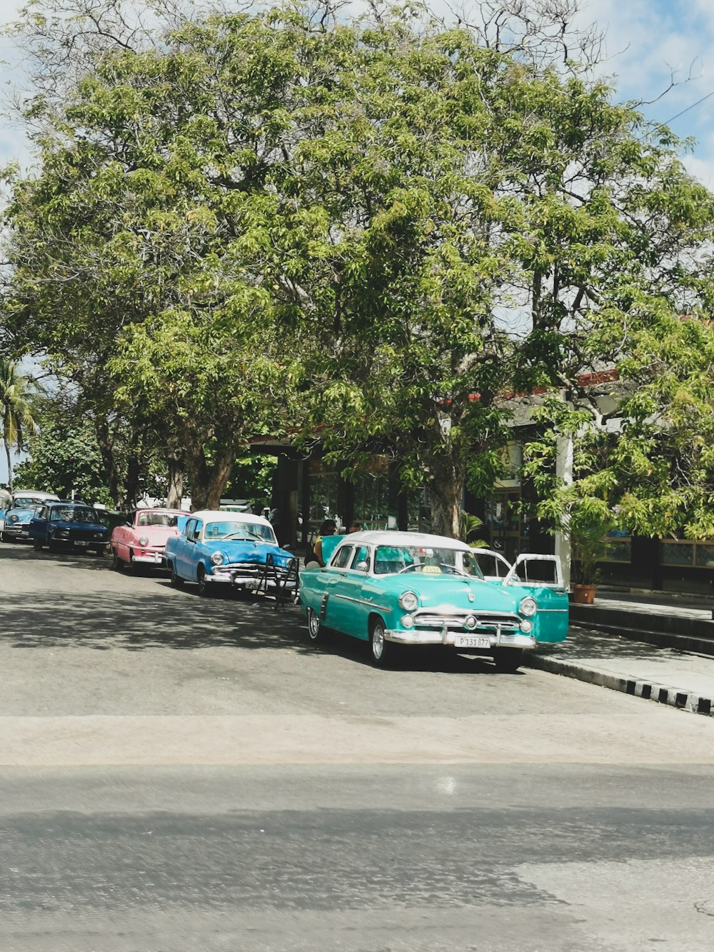 a row of cars parked on the side of a road
